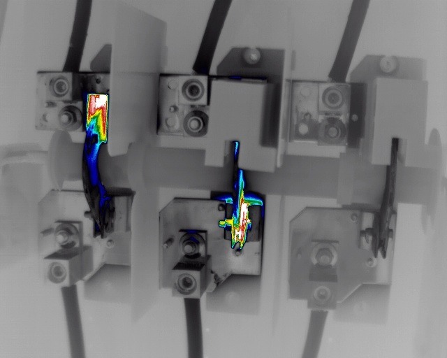 Thermal image showing hot spots at electrical connections in control panel components