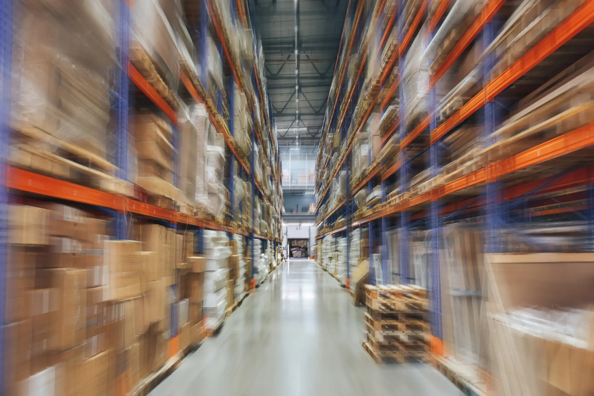 Large Logistics hangar warehouse with lots shelves or racks with pallets of goods