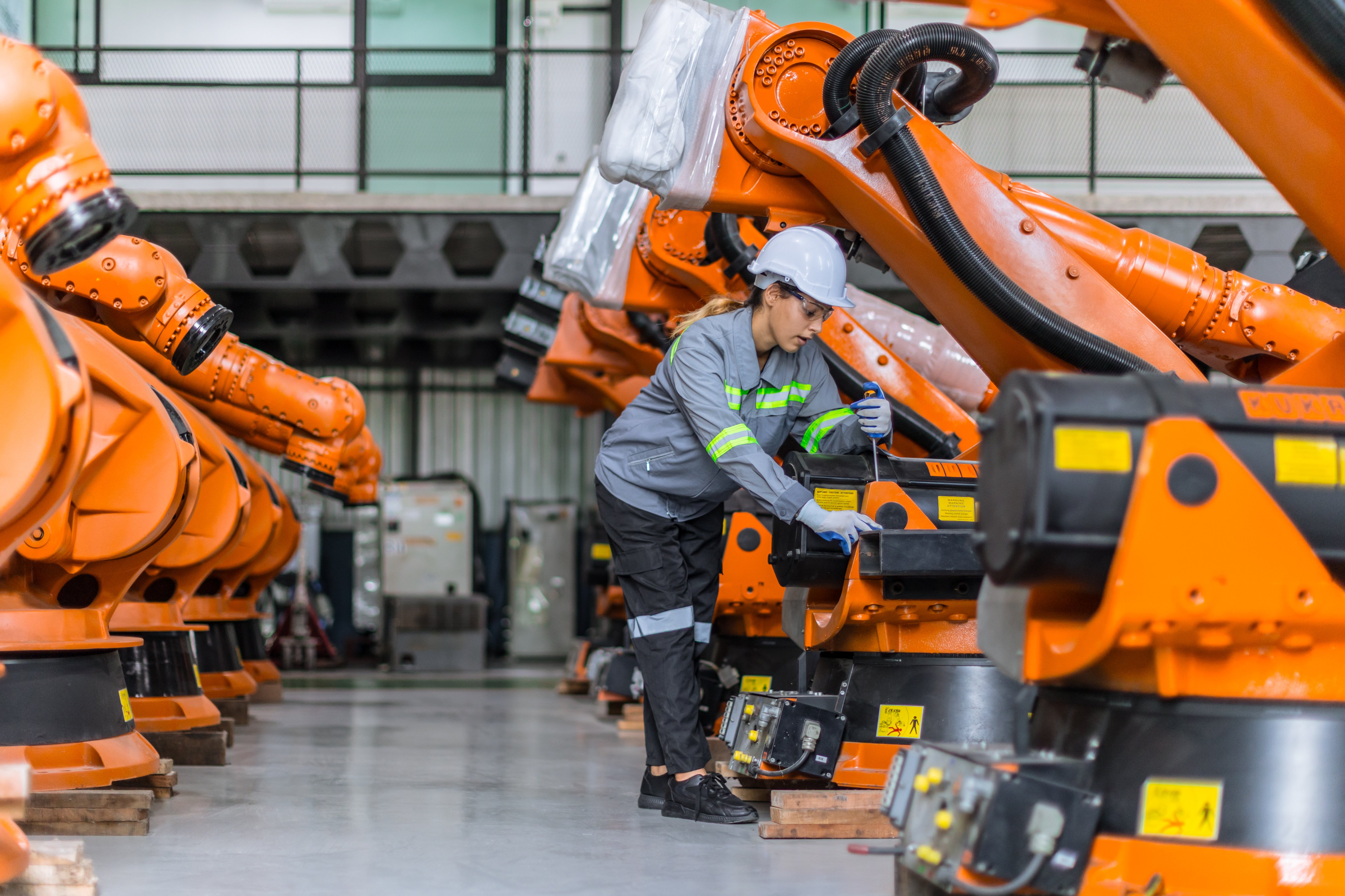 Robotic automation cell operating in a high-throughput warehouse fulfillment and conveyor sortation environment.