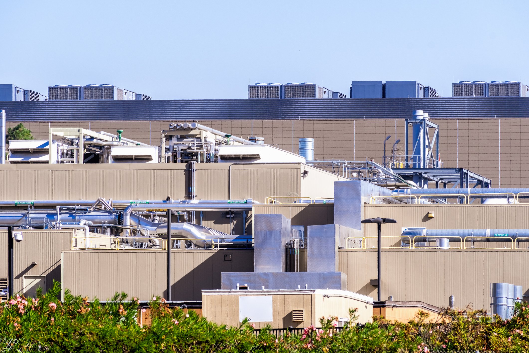 Exterior view of data center cooling and HVAC infrastructure used to illustrate condition monitoring of chillers, cooling systems, airflow equipment, and redundant thermal management assets during failovers and load transfer events. 