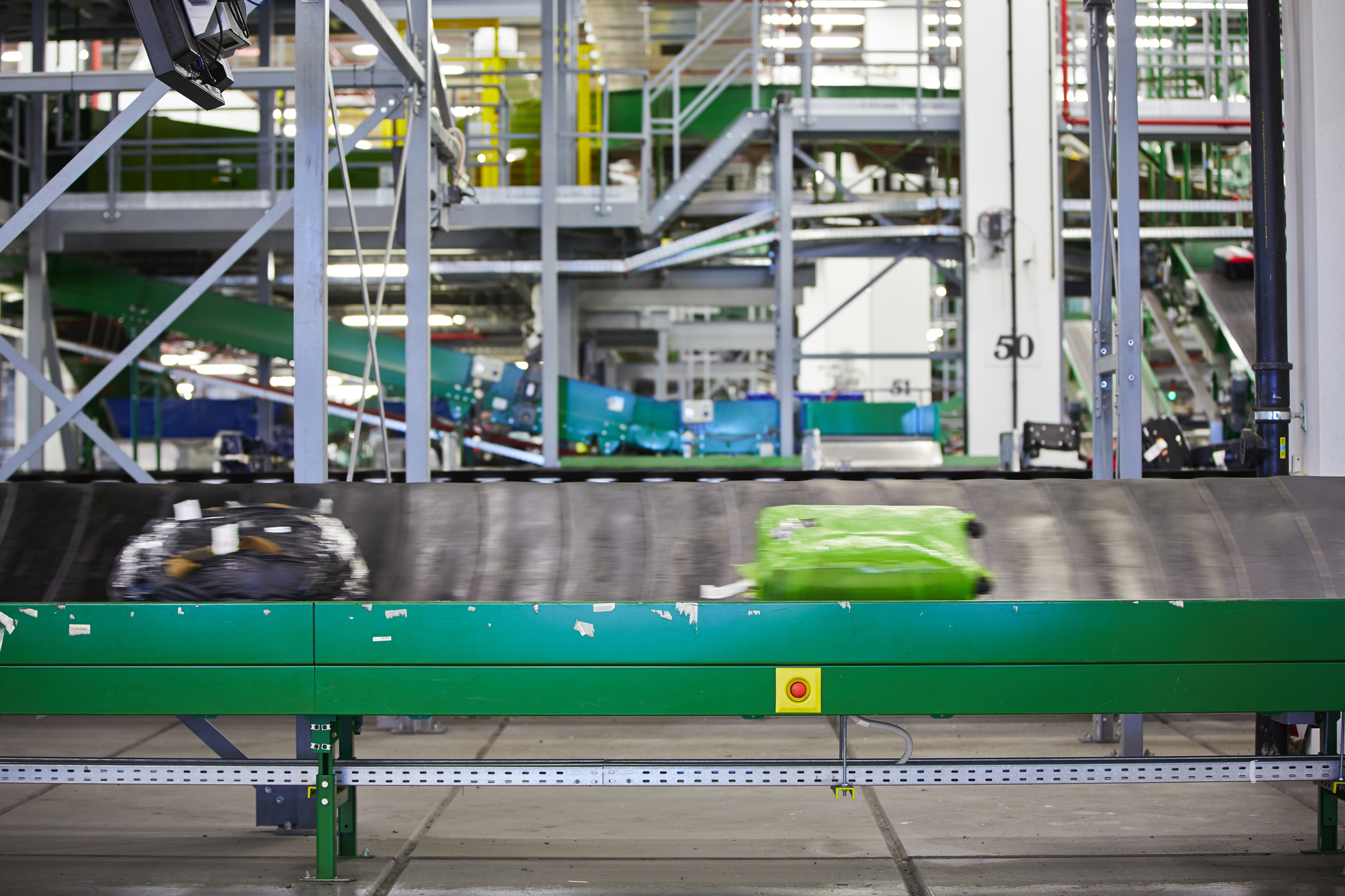 180068681-Baggage on conveyor belt at the airport - selective focus